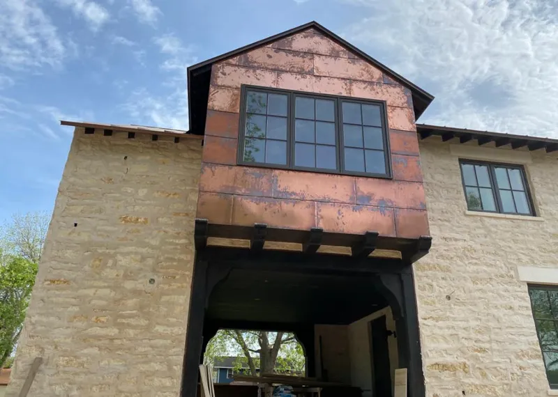 Copper metal panel facade on a stone building for Skylight Installation in Makaha