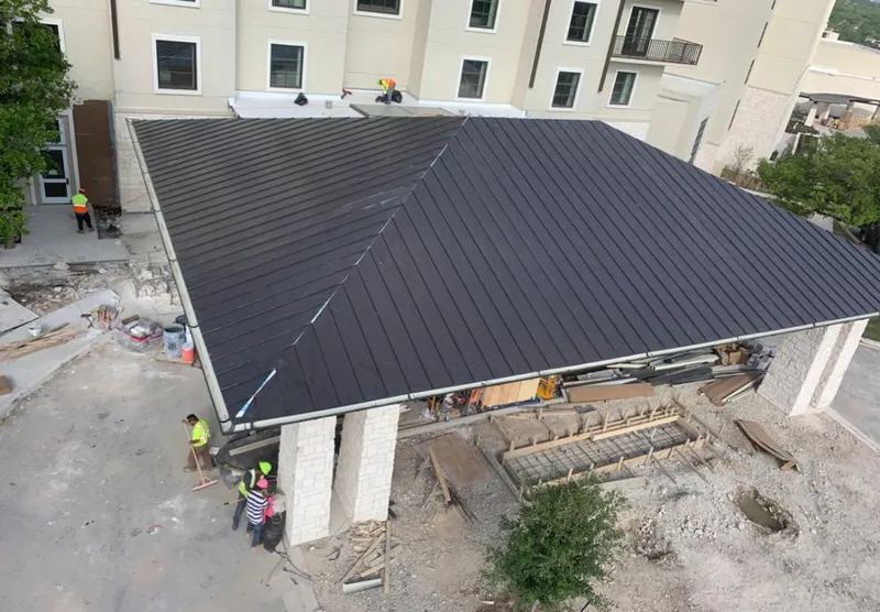 Metal roofing installation team working on a commercial building in Makaha
